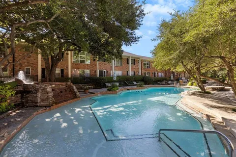 a view of a house with swimming pool and sitting area