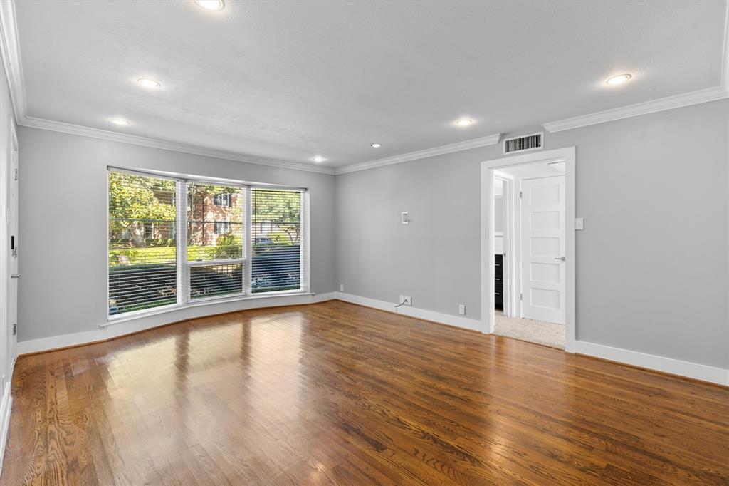 3012 Mahanna Springs Drive, Unit A Dallas, TX 75235 - Photo 5 of 29 a view of an empty room with wooden floor and a window