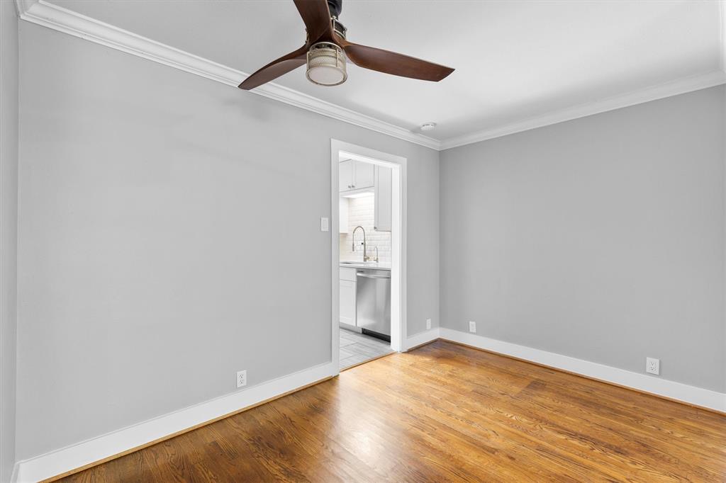 3012 Mahanna Springs Drive, Unit A Dallas, TX 75235 - Photo 9 of 29 a view of empty room with wooden floor and fan
