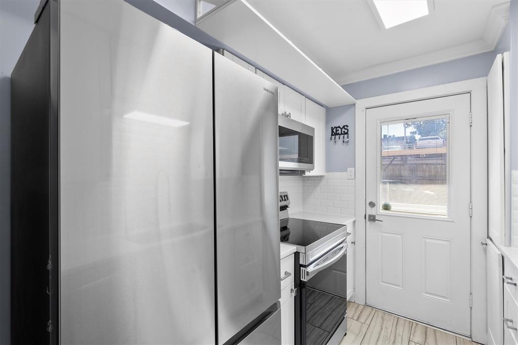 3012 Mahanna Springs Drive, Unit A Dallas, TX 75235 - Photo 10 of 29 a kitchen with white cabinets and sink