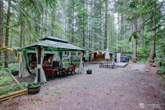 a view of a patio with furniture and a backyard