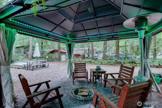 a view of a patio with a table chairs and a backyard