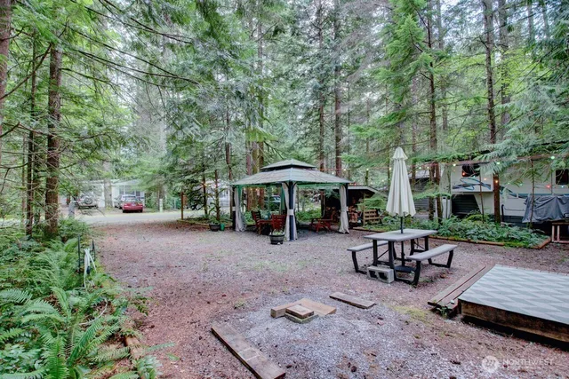 a view of a patio with table and chairs under an umbrella