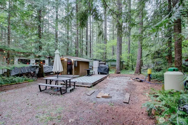 a view of a chair and tables in the backyard