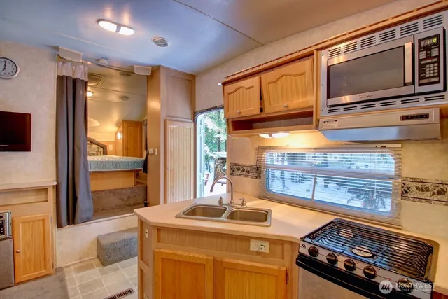 a kitchen with stainless steel appliances granite countertop a stove and a microwave