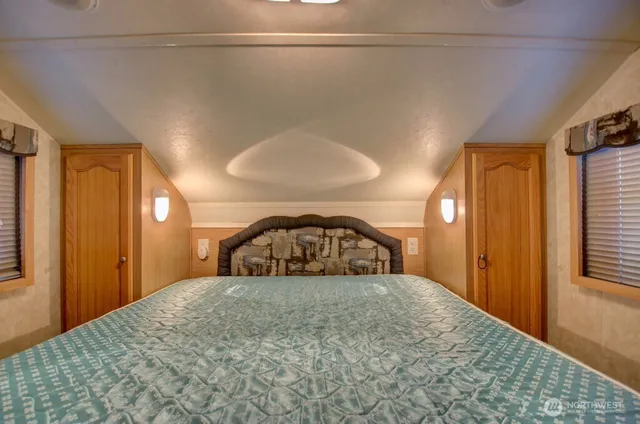 a view of a bedroom with a balcony and a tub