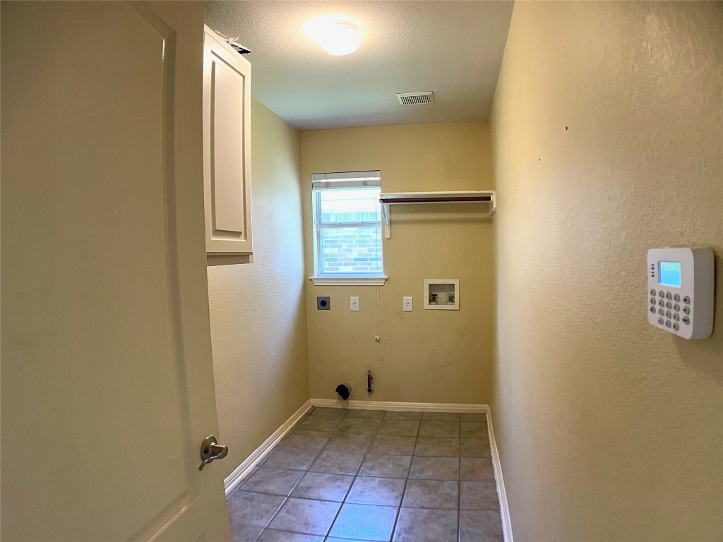 4409 South Summercrest Loop Round Rock, TX 78681 - Photo 24 of 25 Laundry room is conveniently located in hallway near garage entrance