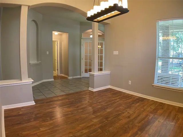 a view of a room with wooden floor and cabinet
