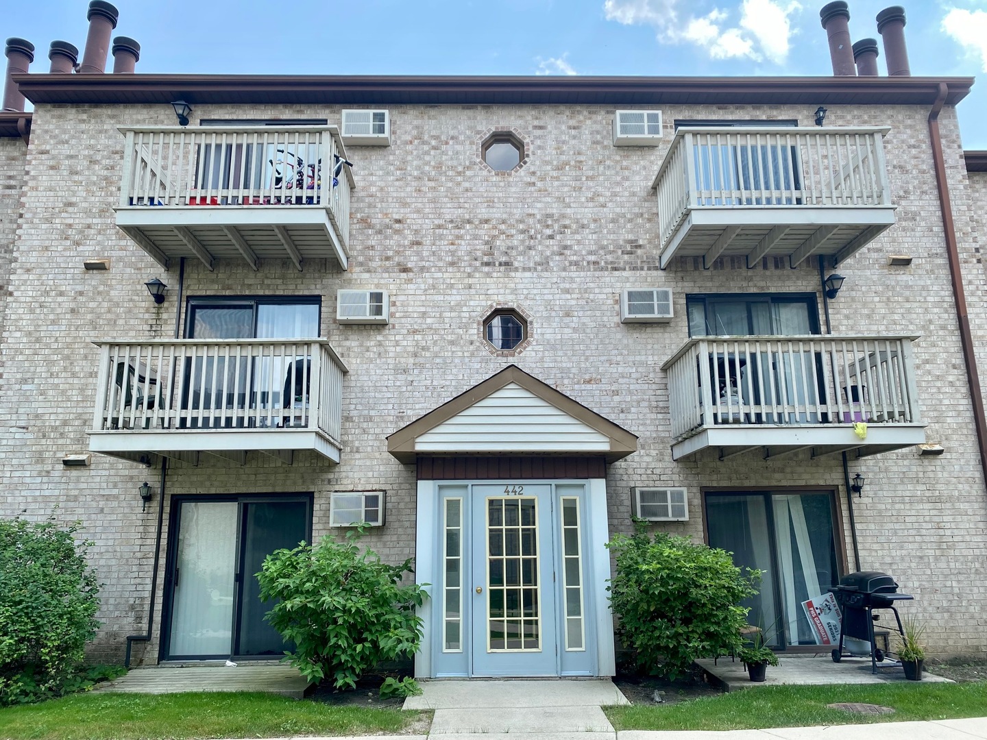 442 East Osage Lane, Unit 3B Palatine, IL 60074 - Photo 1 of 7 a front view of a house with garden and plants