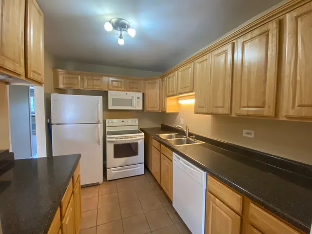 a kitchen with a refrigerator and a sink