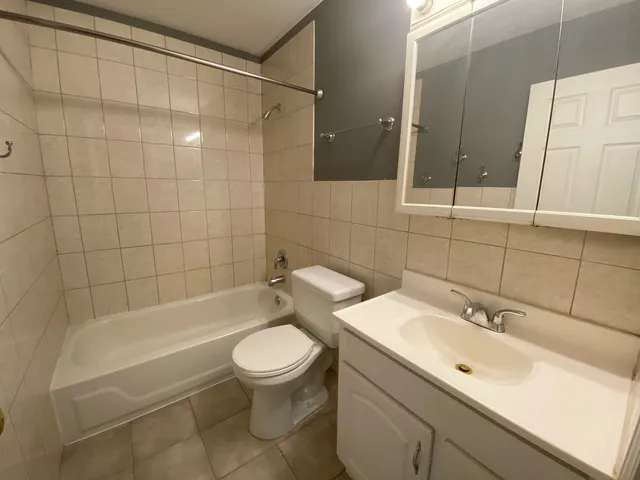 a bathroom with a sink mirror toilet and bathtub