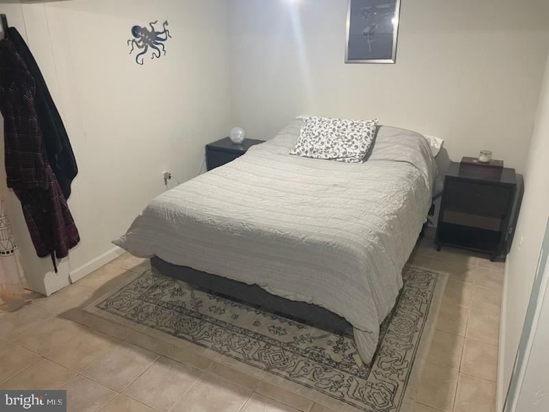 7021 Mower Street, Unit 1 Philadelphia, PA 19119 - Photo 3 of 3 a bedroom with a bed and a rug