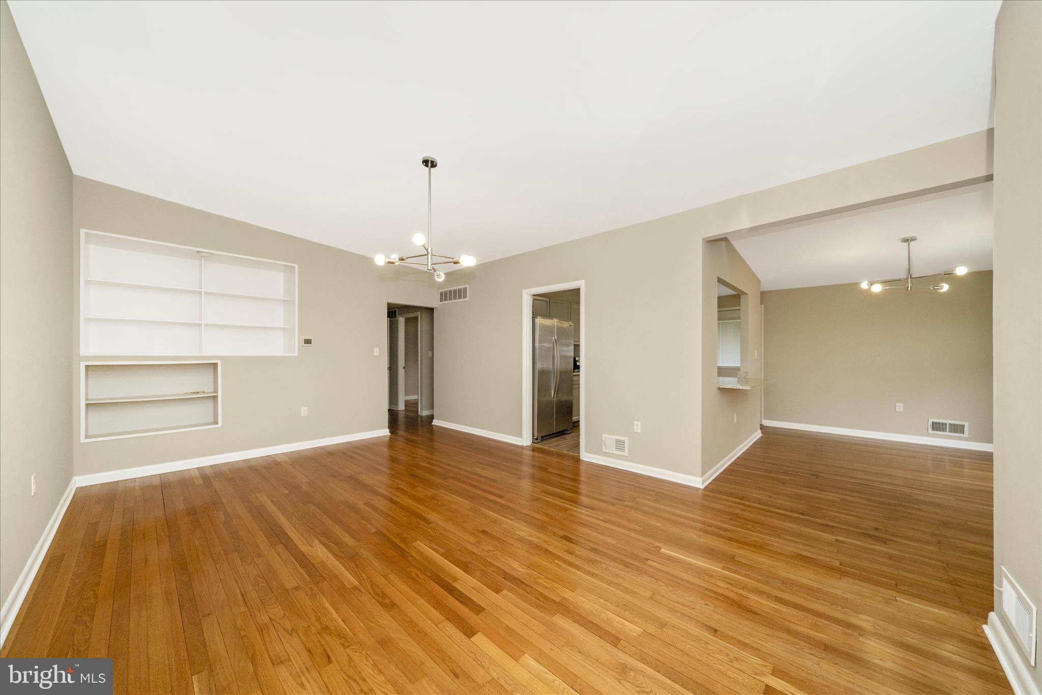 1302 Glenmont Road Baltimore, MD 21239 - Photo 12 of 49 wooden floor in an empty room with a window
