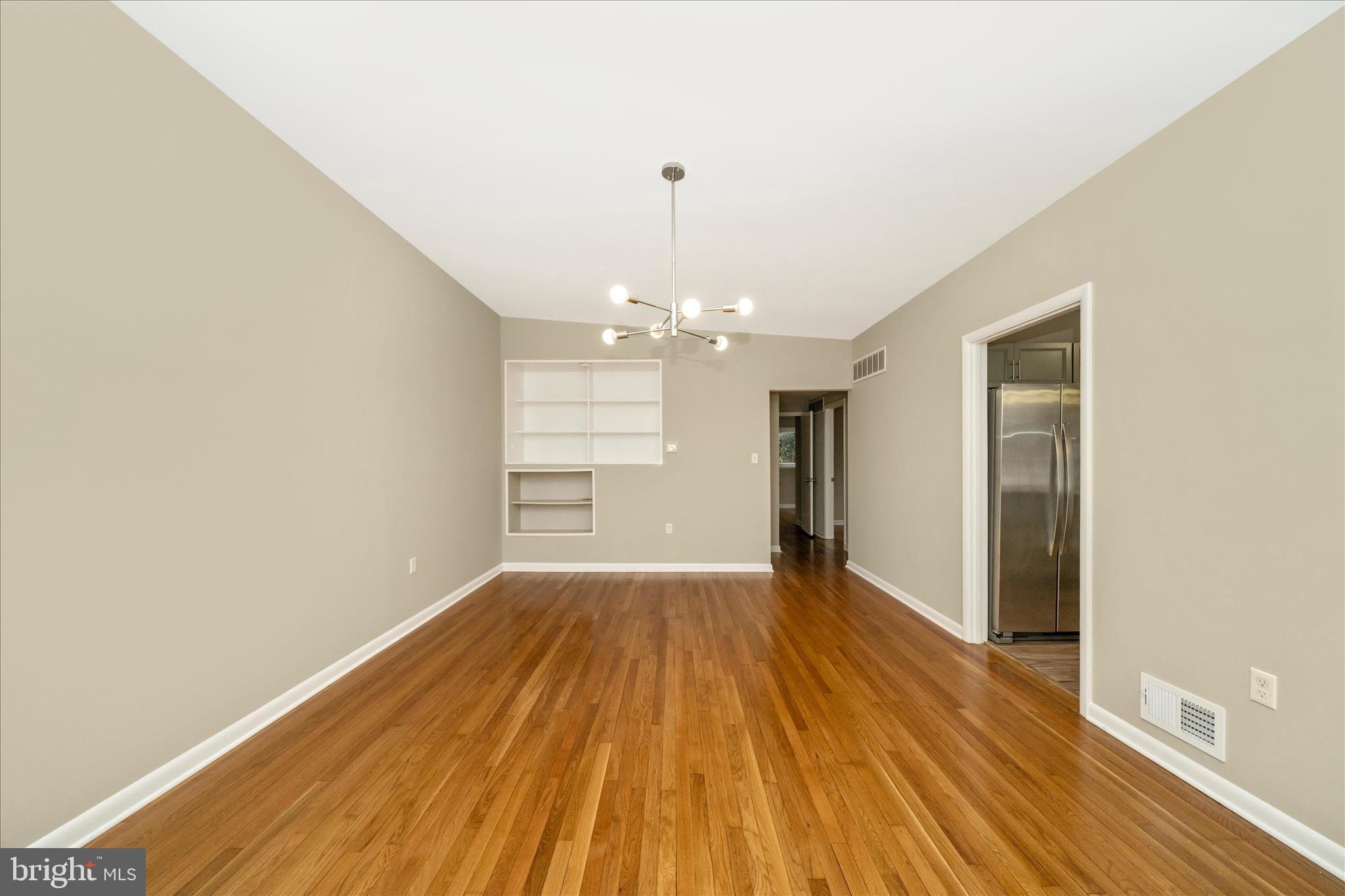 1302 Glenmont Road Baltimore, MD 21239 - Photo 13 of 49 wooden floor in an empty room with a window