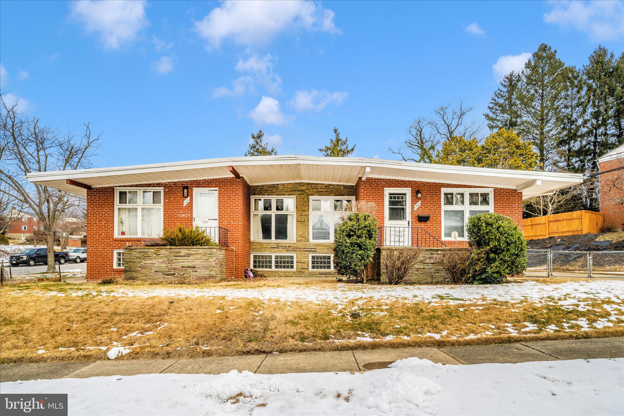 1302 Glenmont Road Baltimore, MD 21239 - Photo 2 of 49 a front view of a house with a yard