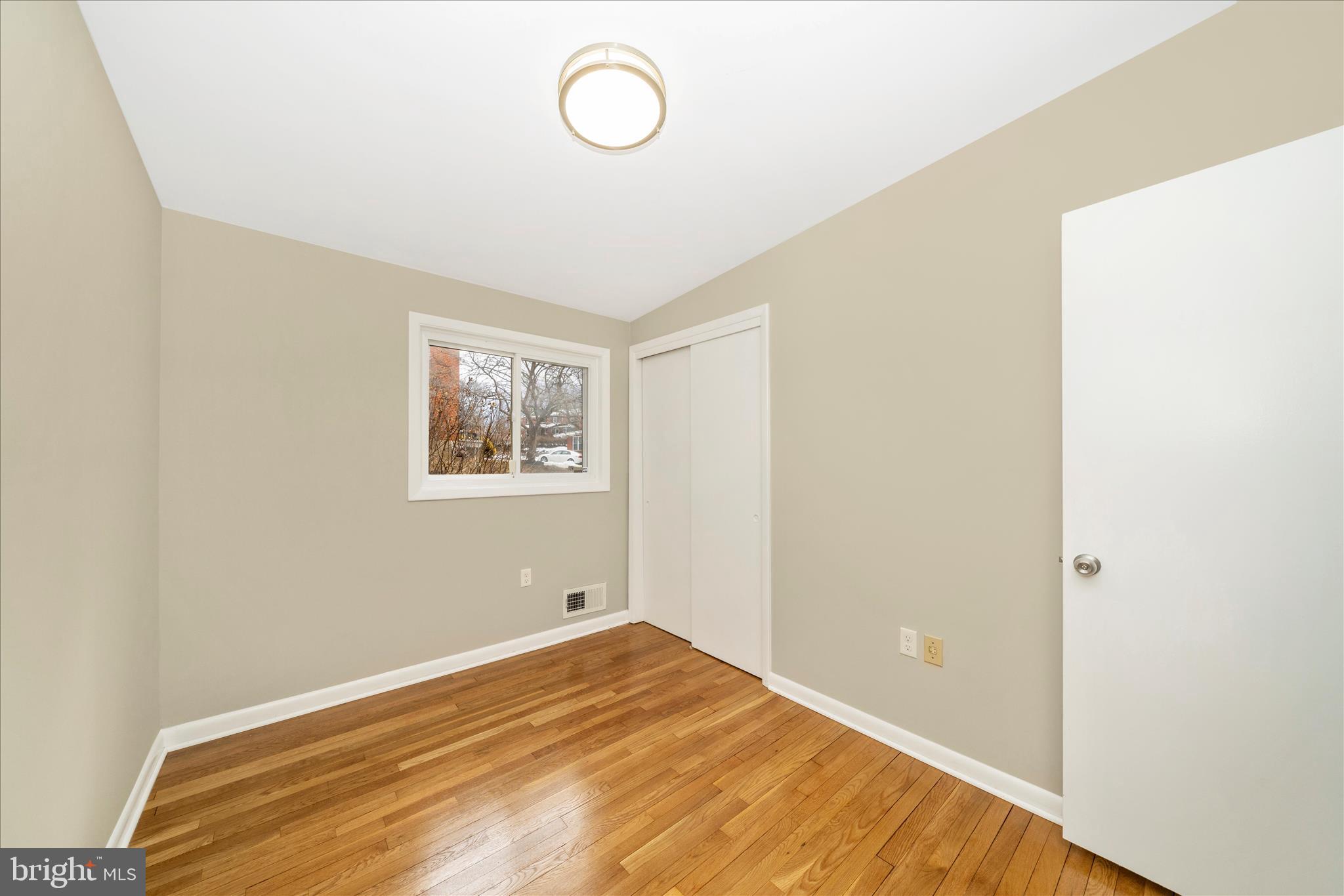 1302 Glenmont Road Baltimore, MD 21239 - Photo 26 of 49 a view of a room with wooden floor and white walls