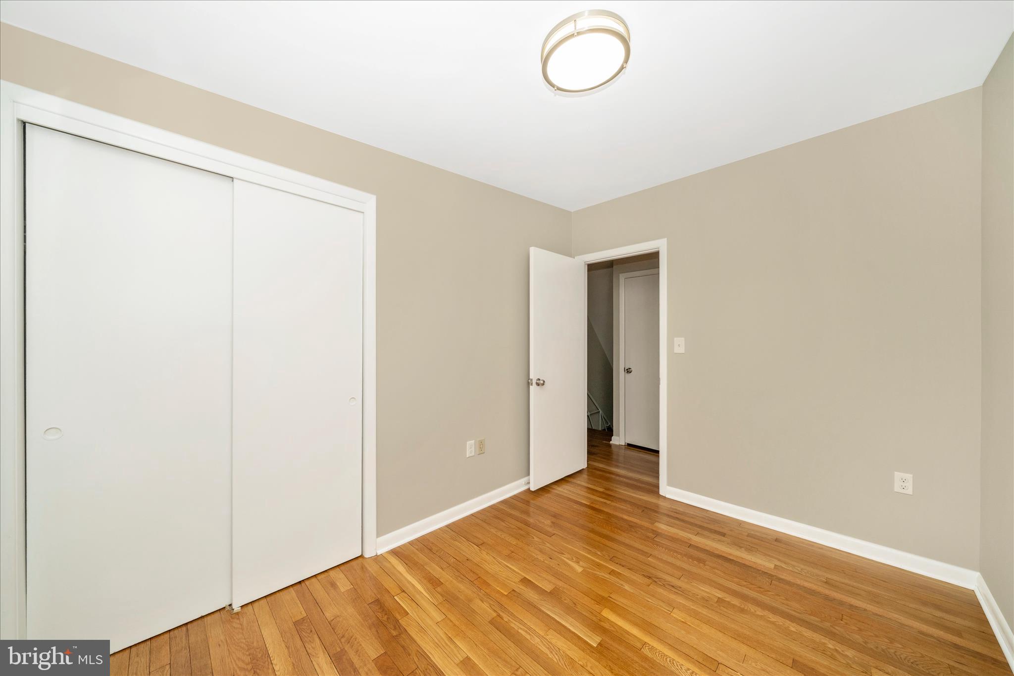 1302 Glenmont Road Baltimore, MD 21239 - Photo 27 of 49 a view of an empty room with wooden floor