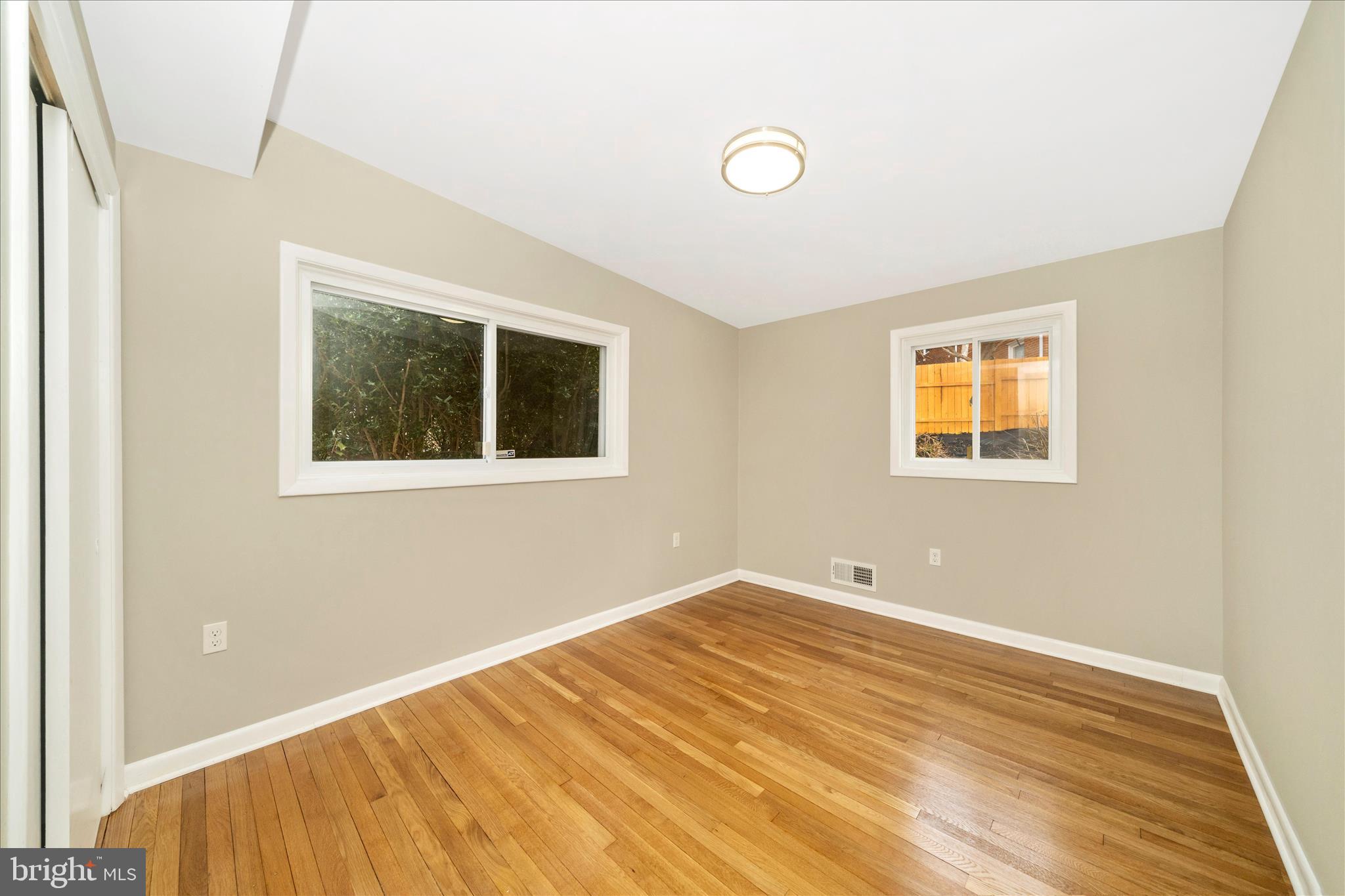 1302 Glenmont Road Baltimore, MD 21239 - Photo 28 of 49 a view of a room with wooden floor and a window