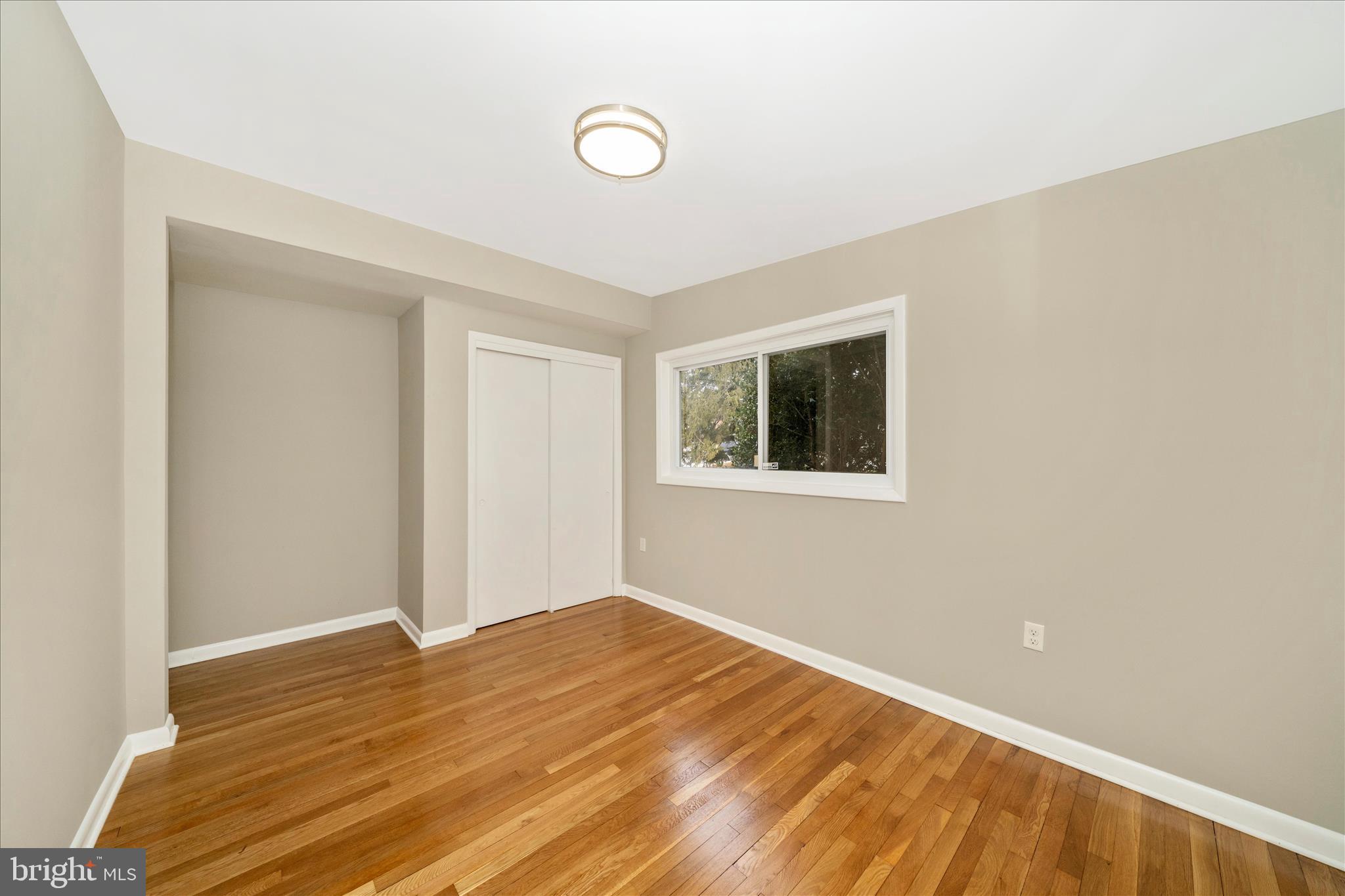 1302 Glenmont Road Baltimore, MD 21239 - Photo 30 of 49 a view of a room with wooden floor and white walls