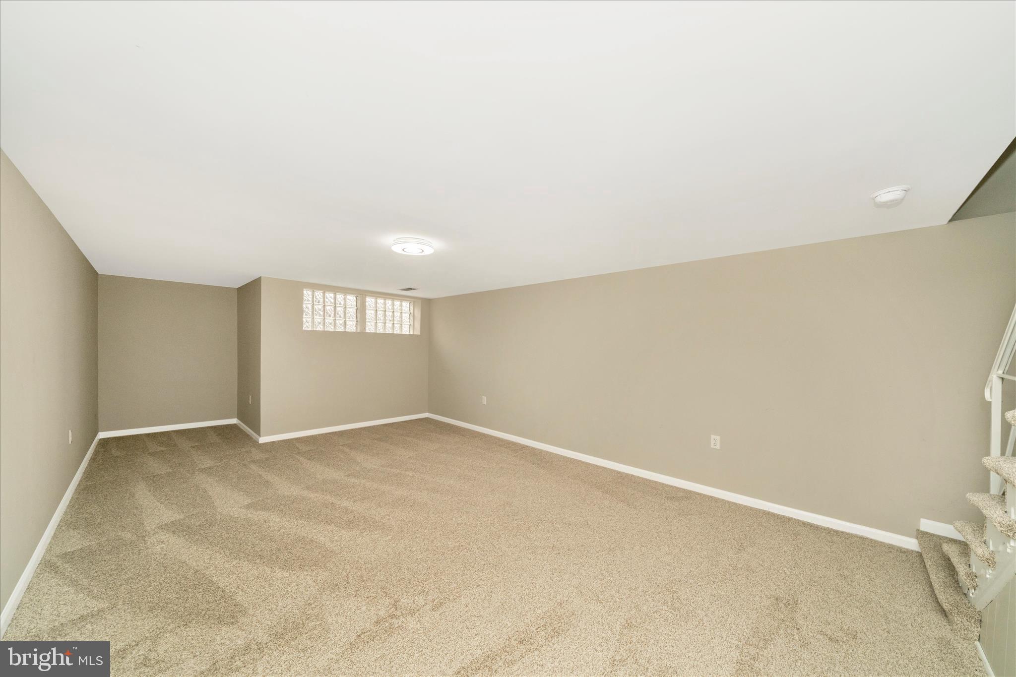 1302 Glenmont Road Baltimore, MD 21239 - Photo 35 of 49 an empty room with windows