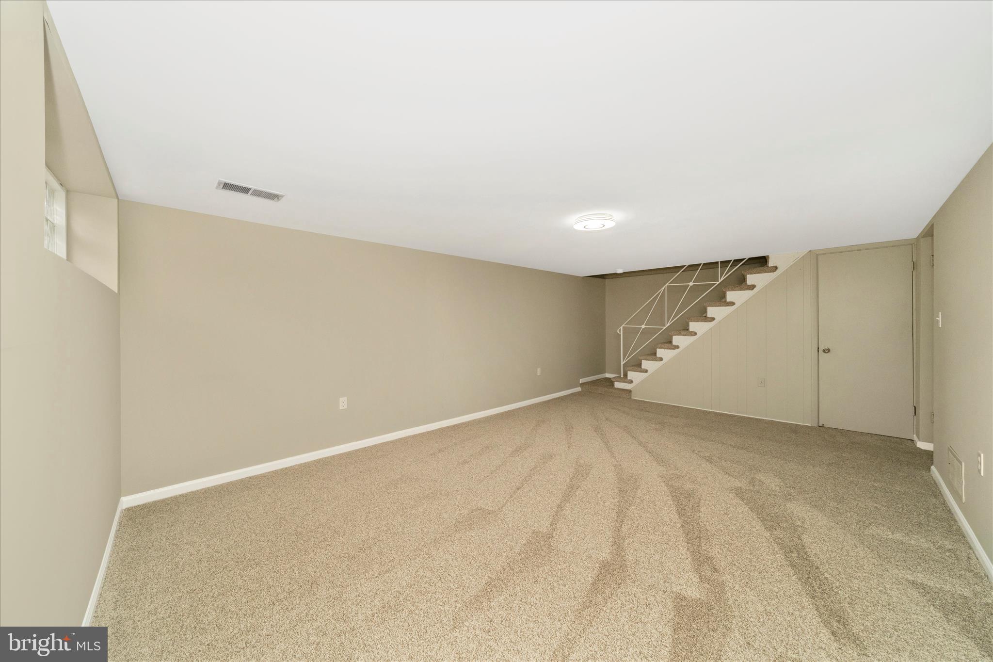 1302 Glenmont Road Baltimore, MD 21239 - Photo 36 of 49 an empty room with a empty space and windows