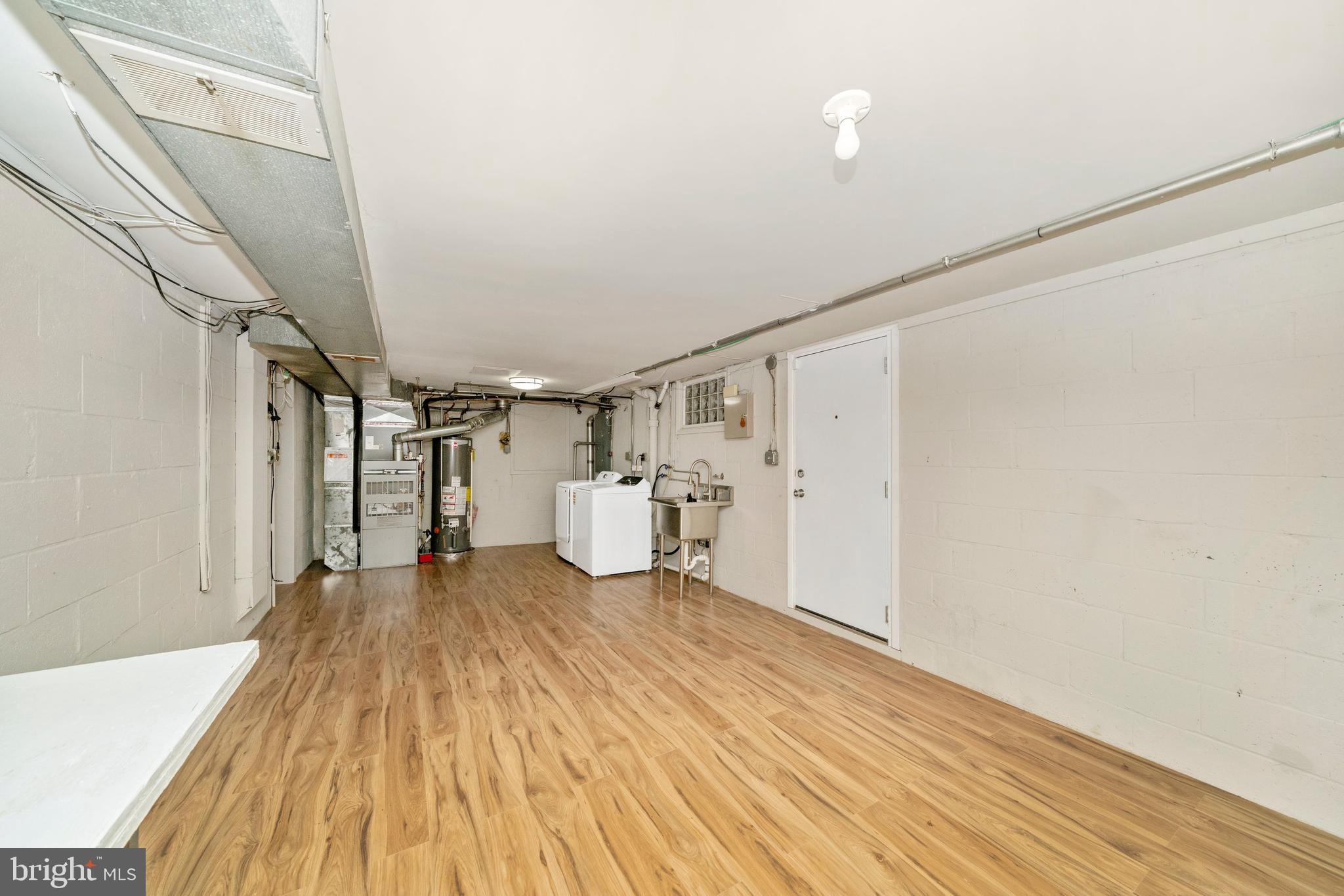 1302 Glenmont Road Baltimore, MD 21239 - Photo 44 of 49 a view of empty room with wooden floor