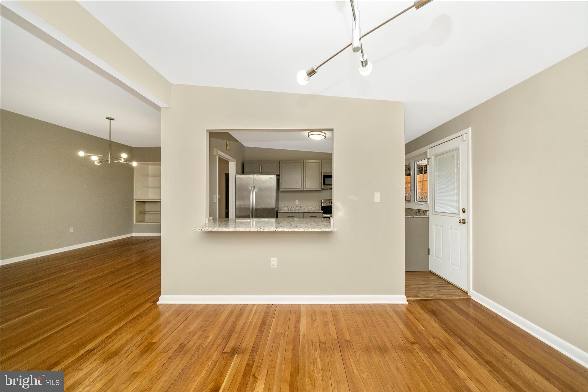 1302 Glenmont Road Baltimore, MD 21239 - Photo 8 of 49 a view of a hallway with wooden floor and a bathroom