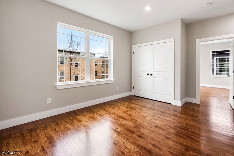 9-11 Marie Place, Unit 2 Newark, NJ 07112 - Photo 10 of 11 a view of livingroom with hardwood floor and window