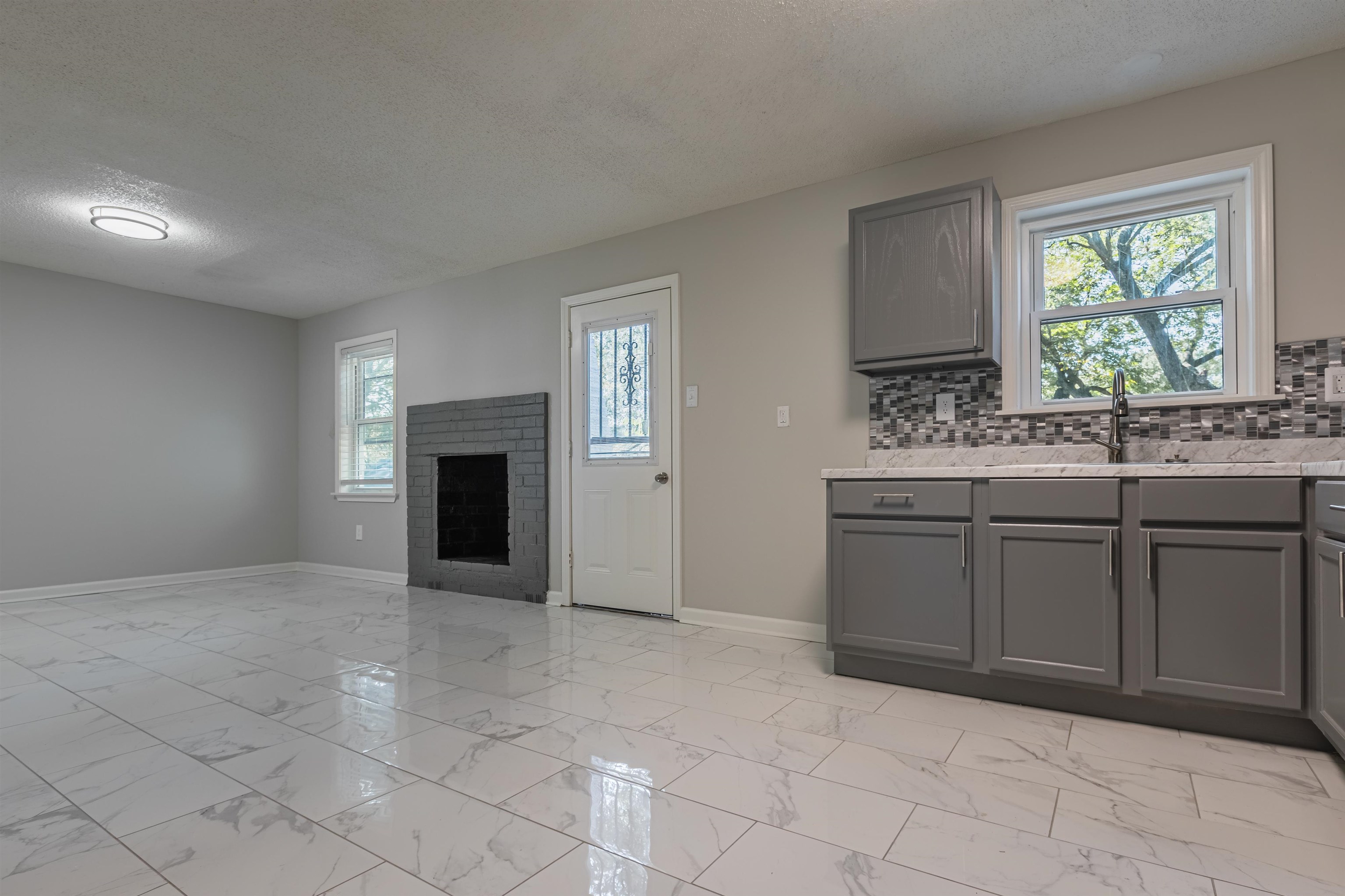 4951 Rosefield Road Memphis, TN 38118 - Photo 14 of 20 a kitchen with a sink and a stove top oven