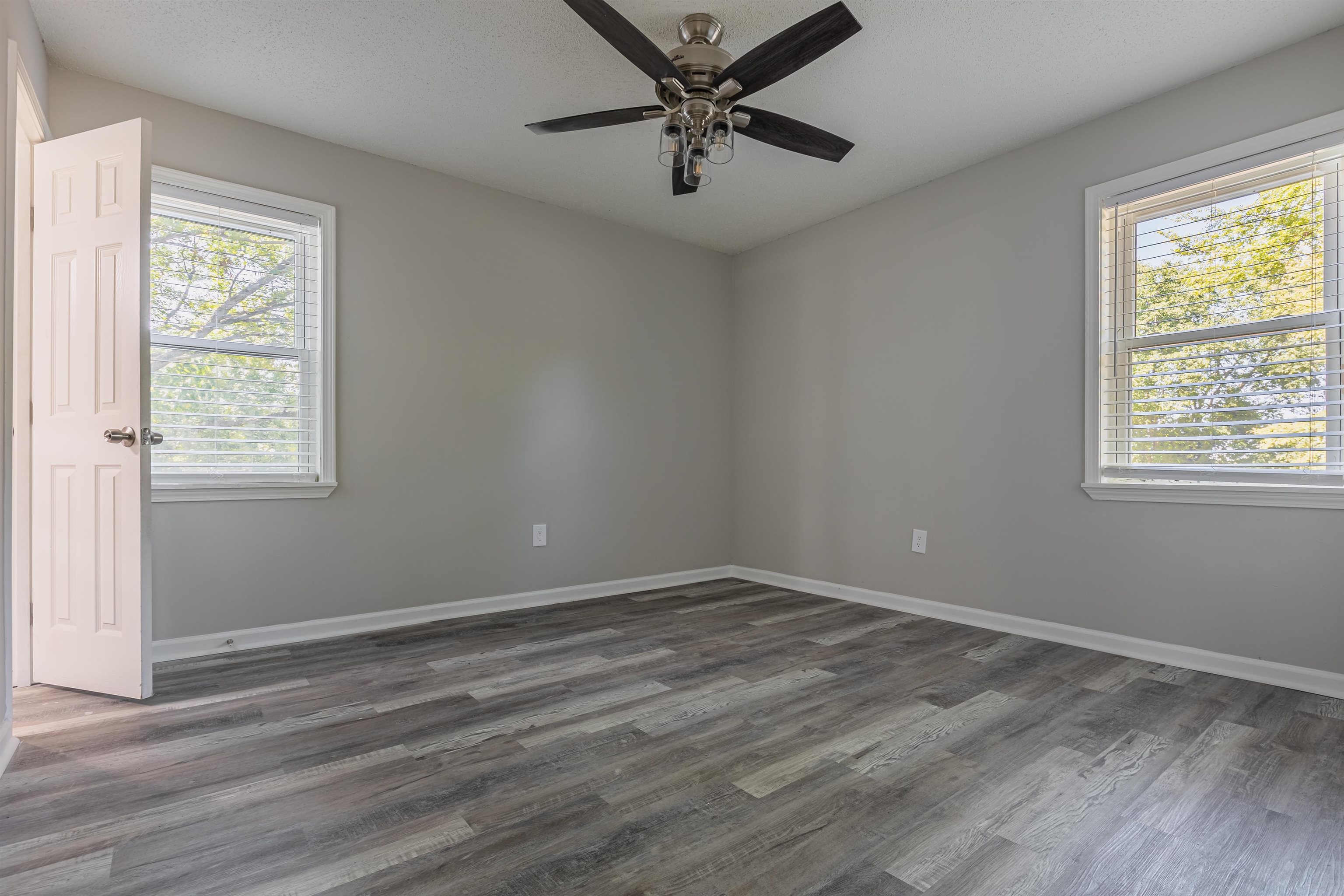 4951 Rosefield Road Memphis, TN 38118 - Photo 15 of 20 a view of an empty room with wooden floor and a window