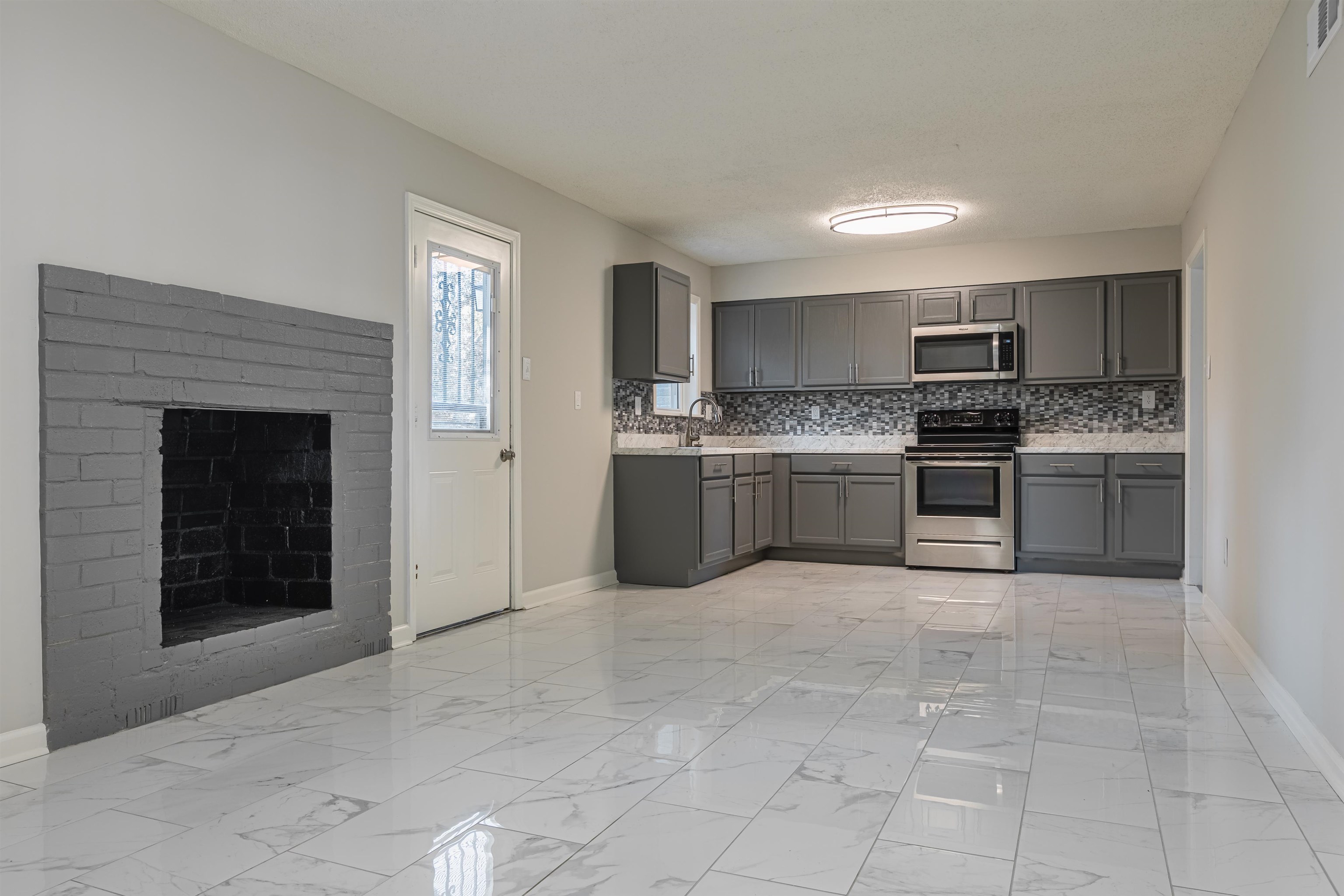 4951 Rosefield Road Memphis, TN 38118 - Photo 6 of 20 a large kitchen with cabinets and stainless steel appliances