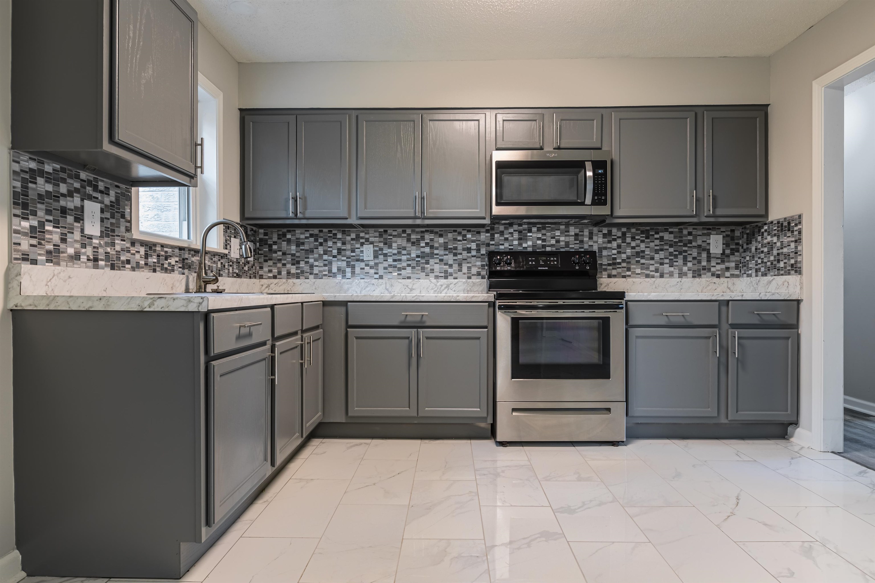 4951 Rosefield Road Memphis, TN 38118 - Photo 7 of 20 a kitchen with sink stainless steel appliances and cabinets