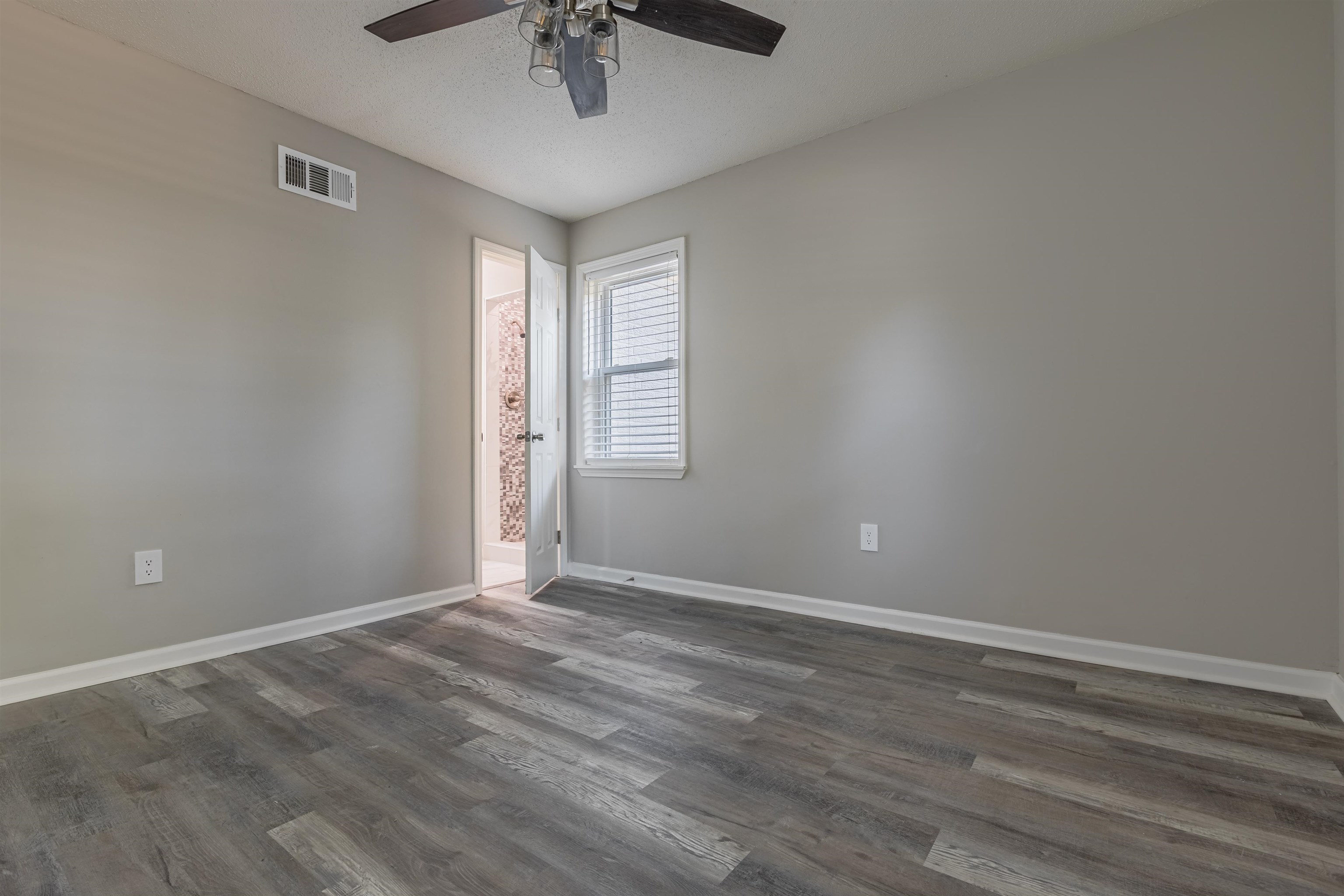 4951 Rosefield Road Memphis, TN 38118 - Photo 8 of 20 a view of an empty room with a window