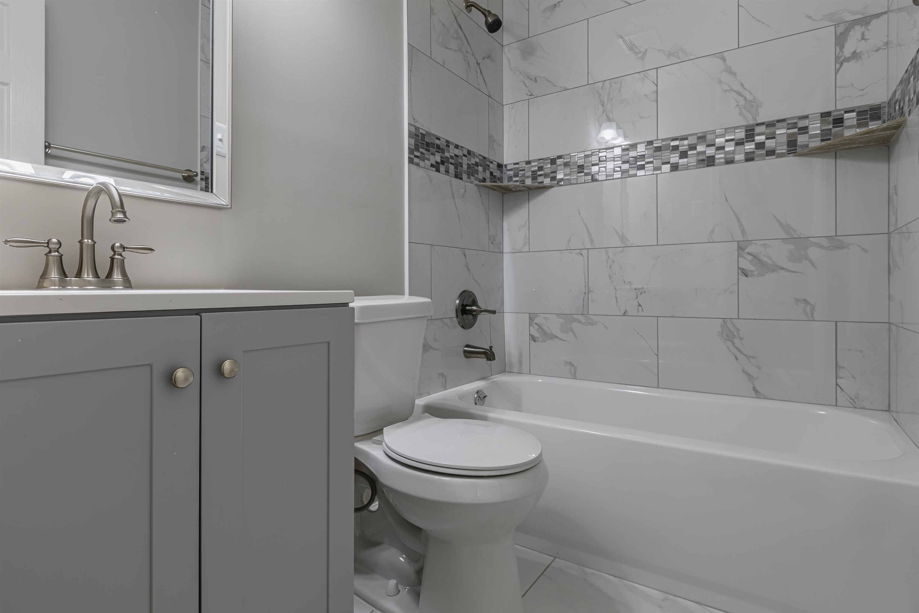 4951 Rosefield Road Memphis, TN 38118 - Photo 9 of 20 a bathroom with a sink a toilet and shower