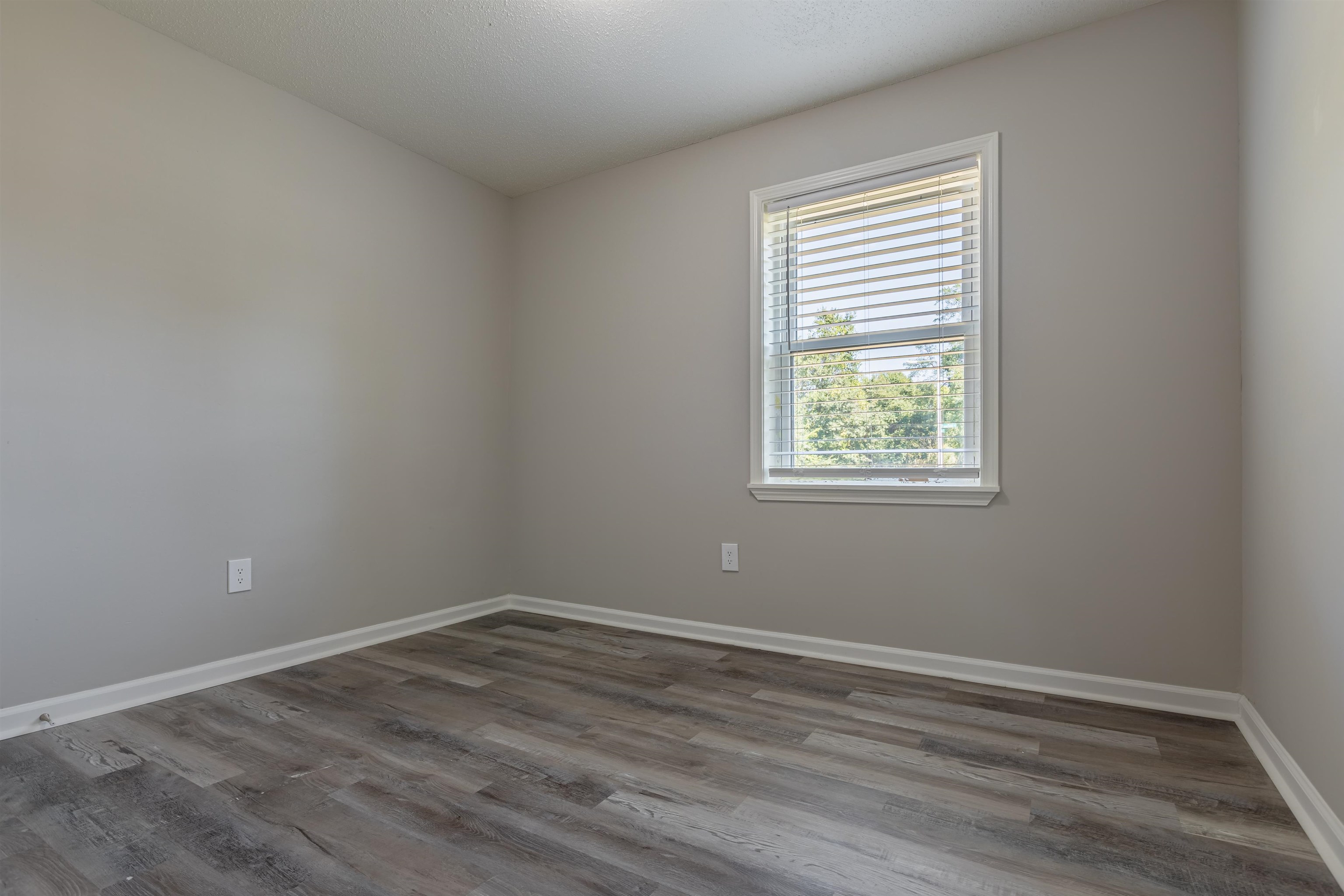 4951 Rosefield Road Memphis, TN 38118 - Photo 10 of 20 wooden floor in an empty room with a window
