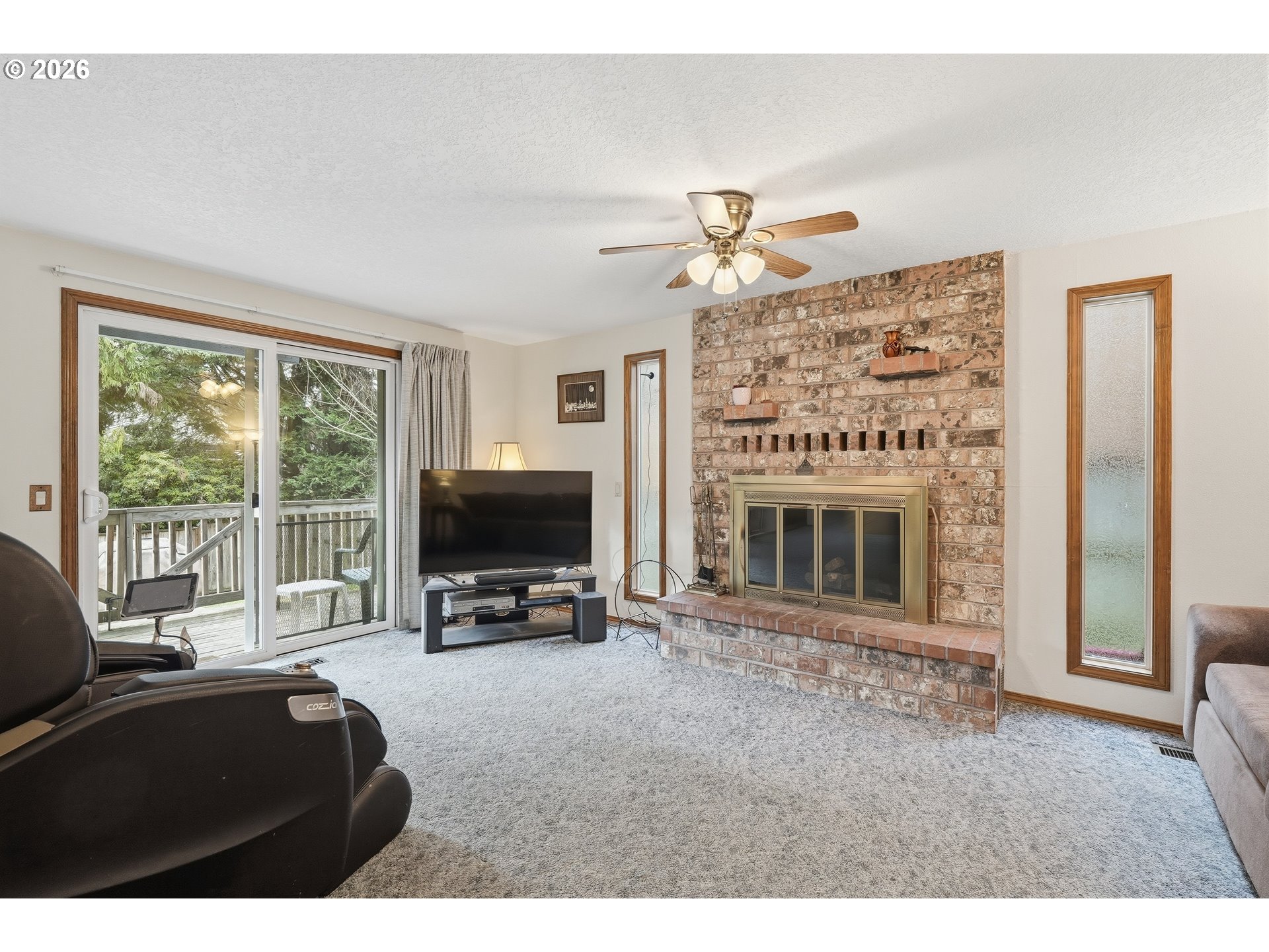 7935 Southwest Carol Glen Place Beaverton, OR 97007 - Photo 14 of 38 a living room with furniture a fireplace and a flat screen tv