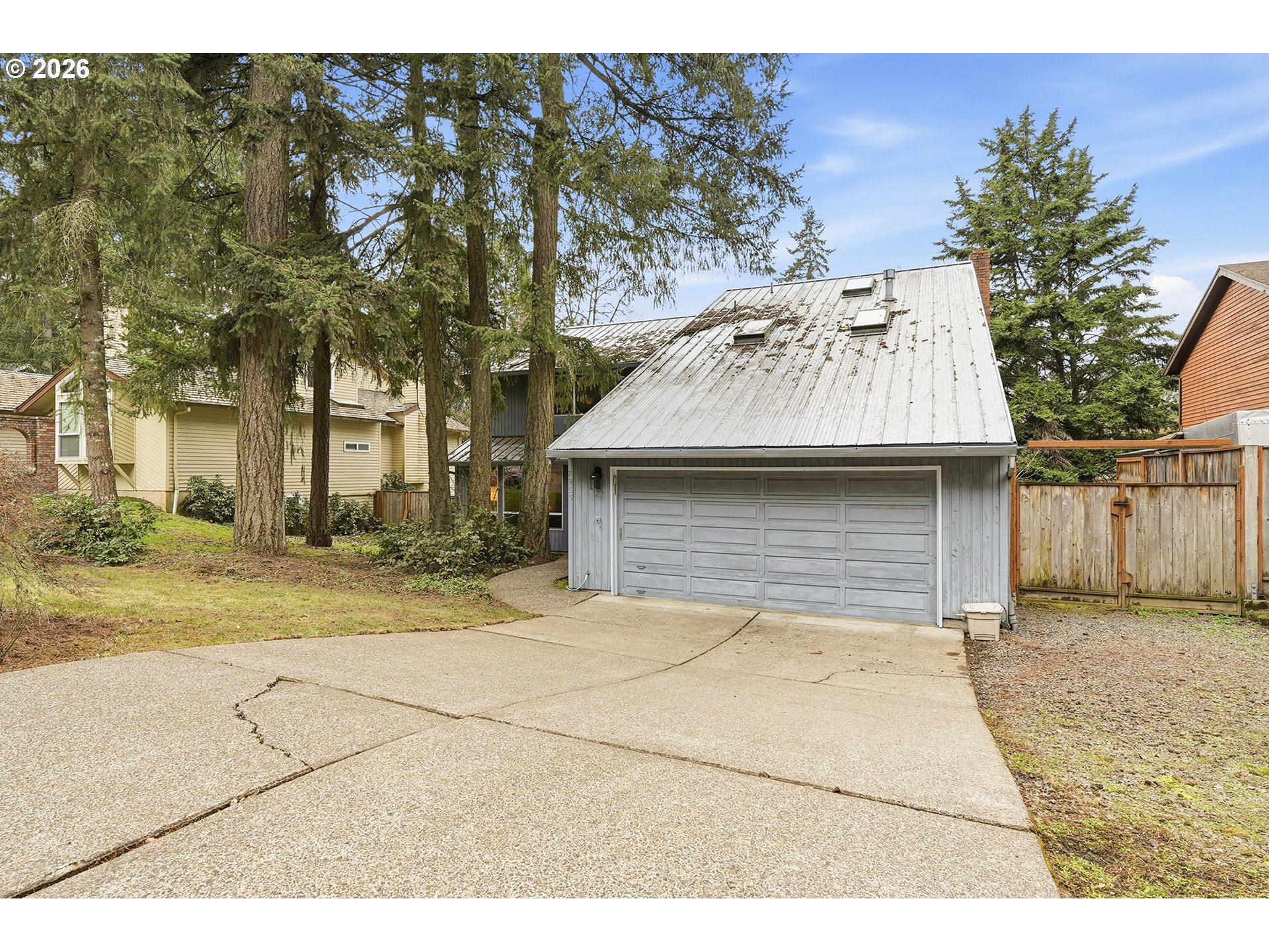 7935 Southwest Carol Glen Place Beaverton, OR 97007 - Photo 2 of 38 a view of a garage with a tree