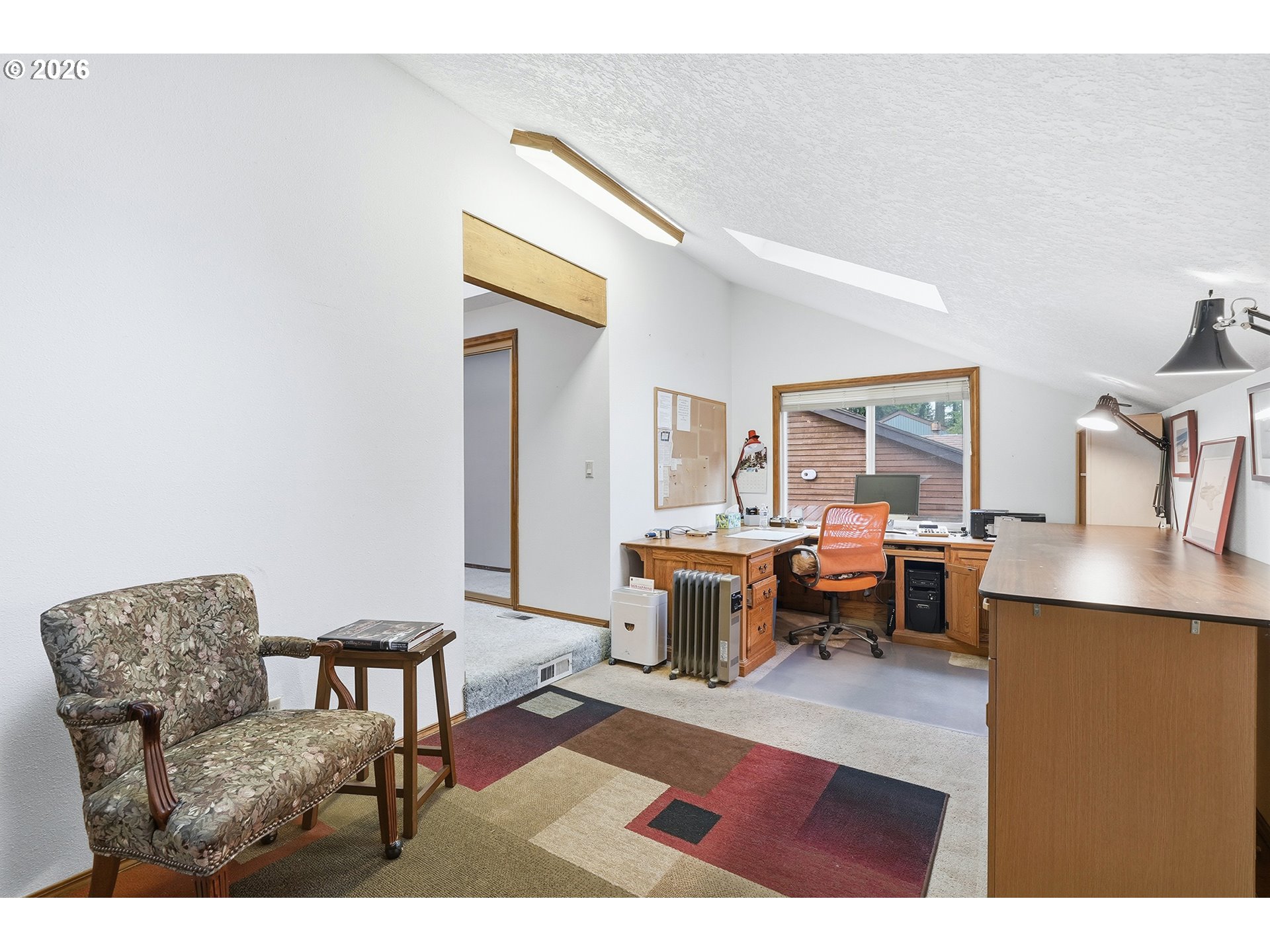 7935 Southwest Carol Glen Place Beaverton, OR 97007 - Photo 31 of 38 a living room with furniture a rug and a table