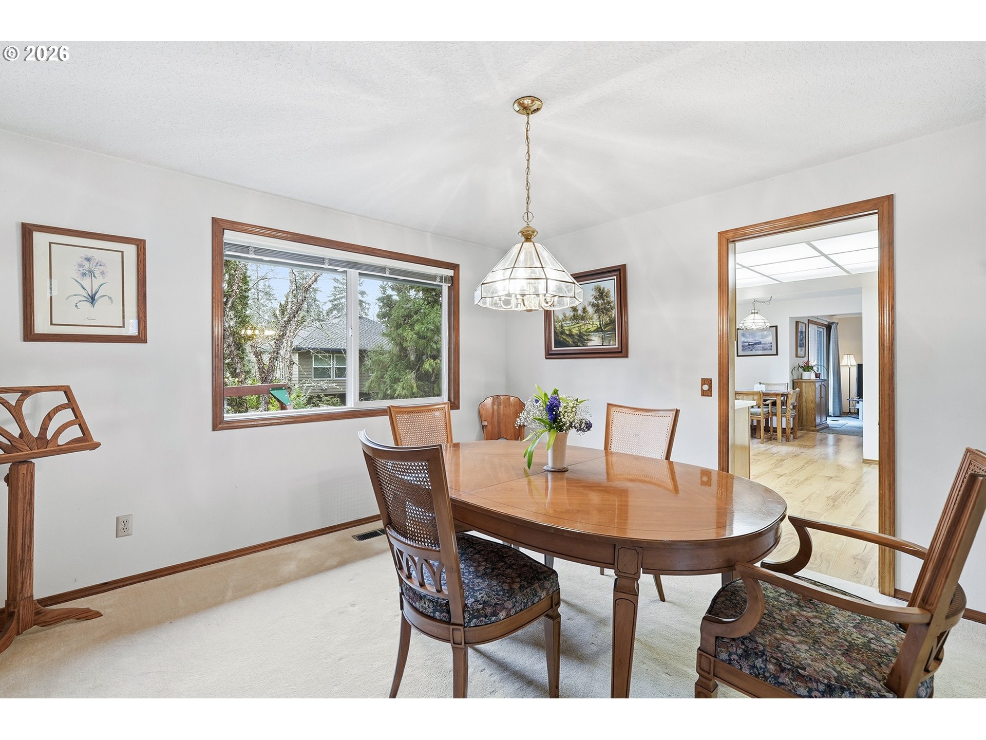 7935 Southwest Carol Glen Place Beaverton, OR 97007 - Photo 8 of 38 a view of a dining room with furniture a chandelier and wooden floor