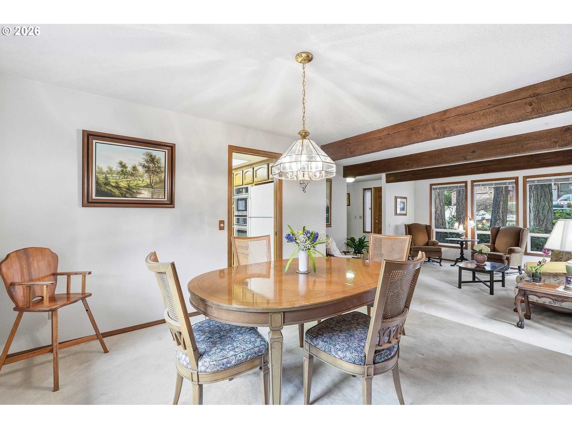 7935 Southwest Carol Glen Place Beaverton, OR 97007 - Photo 9 of 38 a dining room with furniture a chandelier and wooden floor