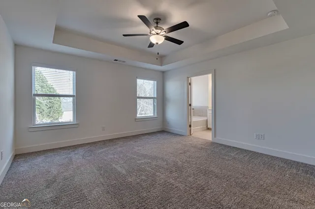 a bathroom with a tub a double vanity sink a vanity and a large mirror