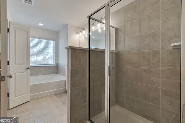 a view of a house with a wooden fence