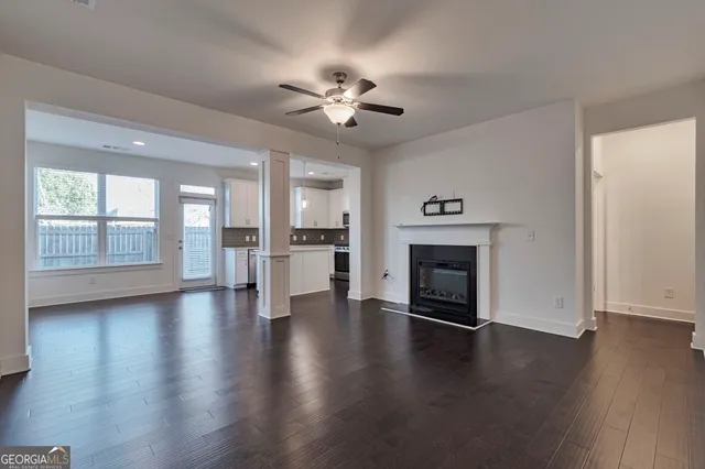 a view of kitchen with sink and refrigerator