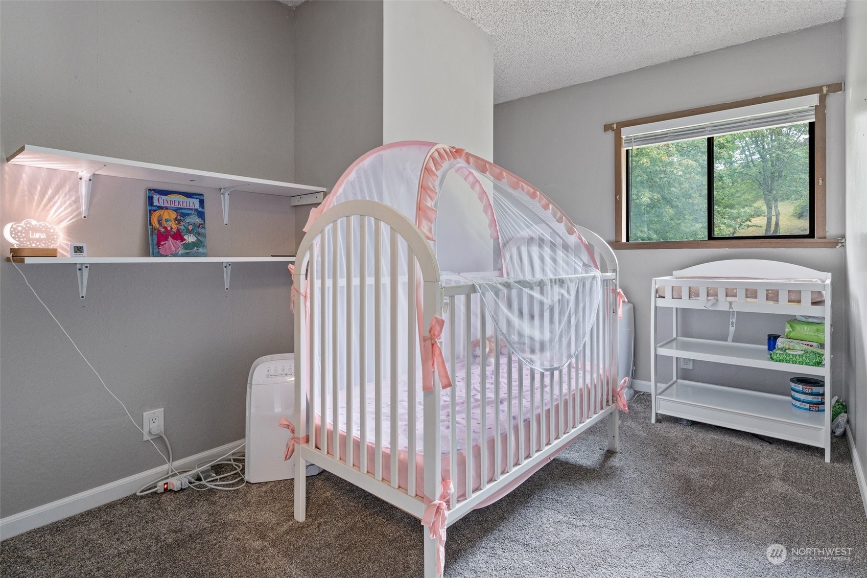 299 Logan Hill Road Chehalis, WA 98532 - Photo 22 of 40 a view of a bedroom with baby crib and a window
