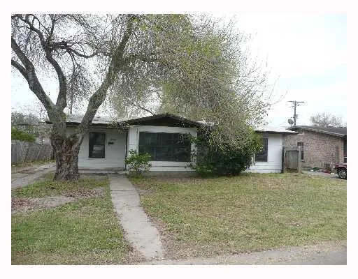 a view of a couches in the patio with a large tree