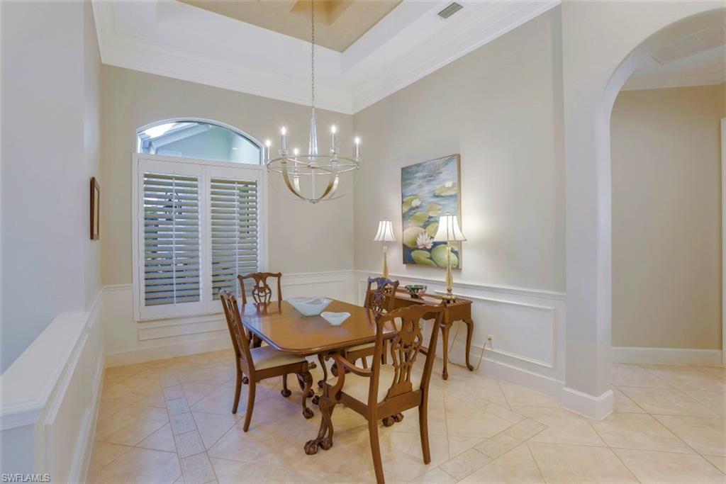 183 Audubon Boulevard Naples, FL 34110 - Photo 11 of 35 a view of a dining room with furniture and chandelier