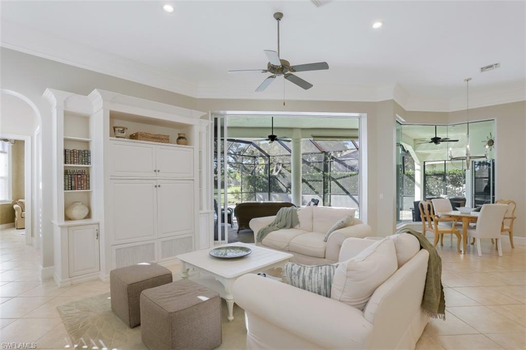 183 Audubon Boulevard Naples, FL 34110 - Photo 15 of 35 a living room with furniture and a large window