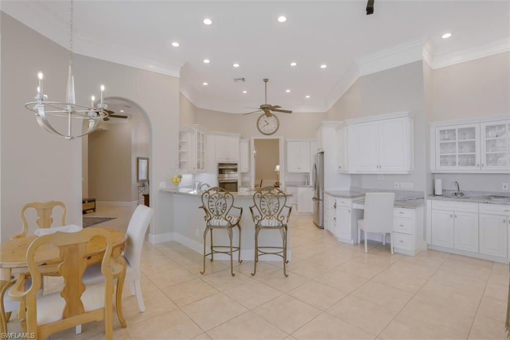 183 Audubon Boulevard Naples, FL 34110 - Photo 17 of 35 a large room with chandelier