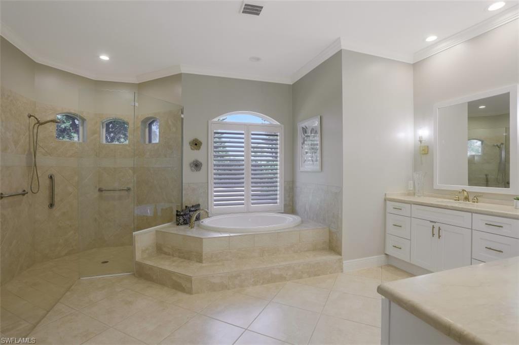 183 Audubon Boulevard Naples, FL 34110 - Photo 19 of 35 a bathroom with a bathtub and a sink