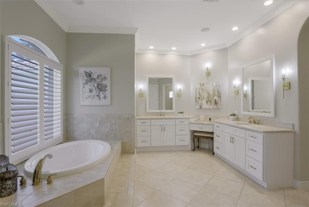 183 Audubon Boulevard Naples, FL 34110 - Photo 20 of 35 a large bathroom with a large tub sink vanity granite and a mirror